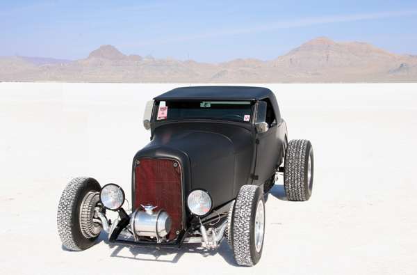 A classic hot rod with finned drum brakes and a flat black paint job